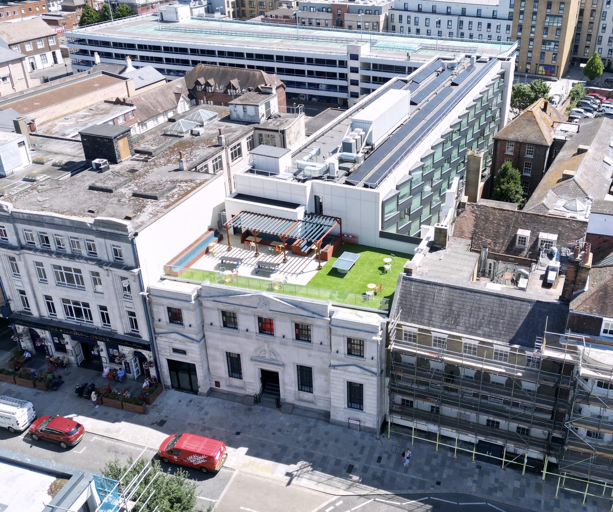 Aerial view of Bargate House, Southampton, showing the retained stone frontage and the landscaped roof terrace.
