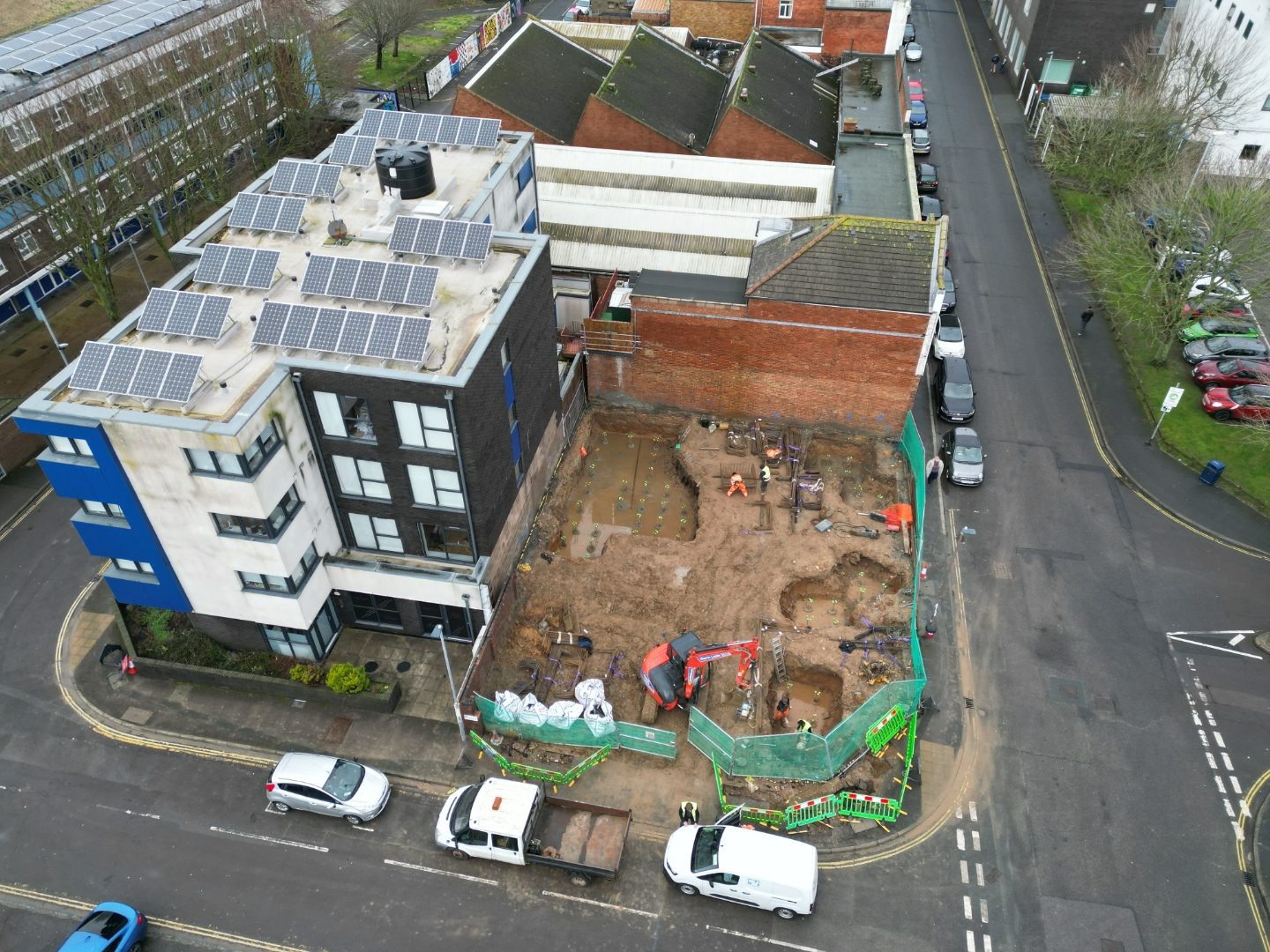 Aerial view of excavated pile caps and ground beams across the site.