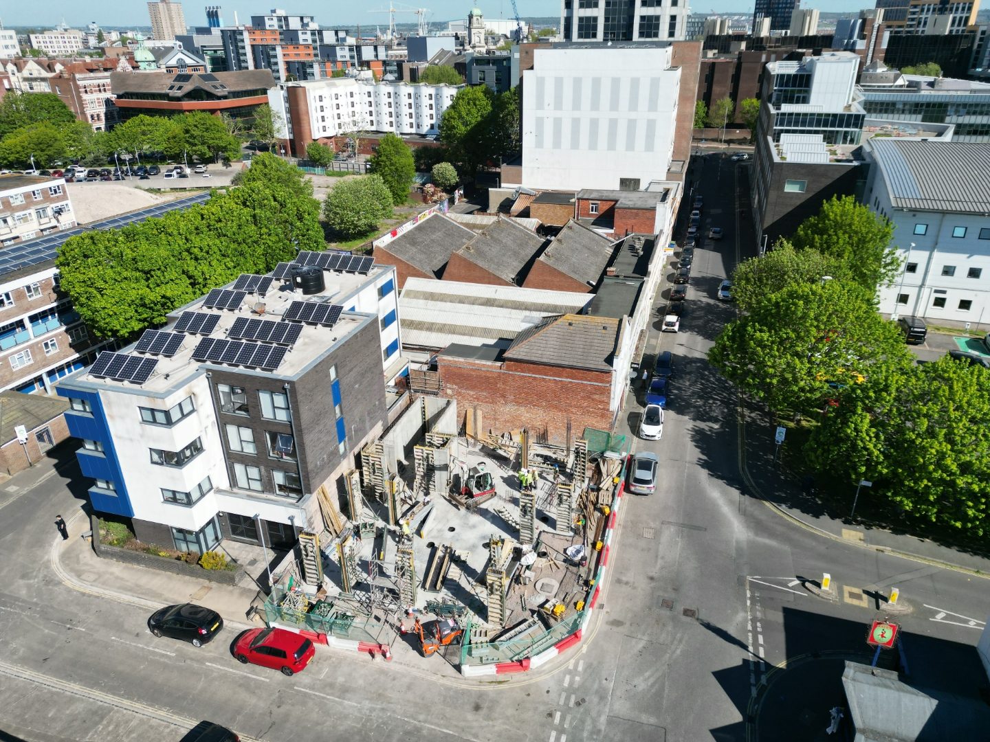Aerial view east across the site towards Portsmouth city centre, with columns rising.